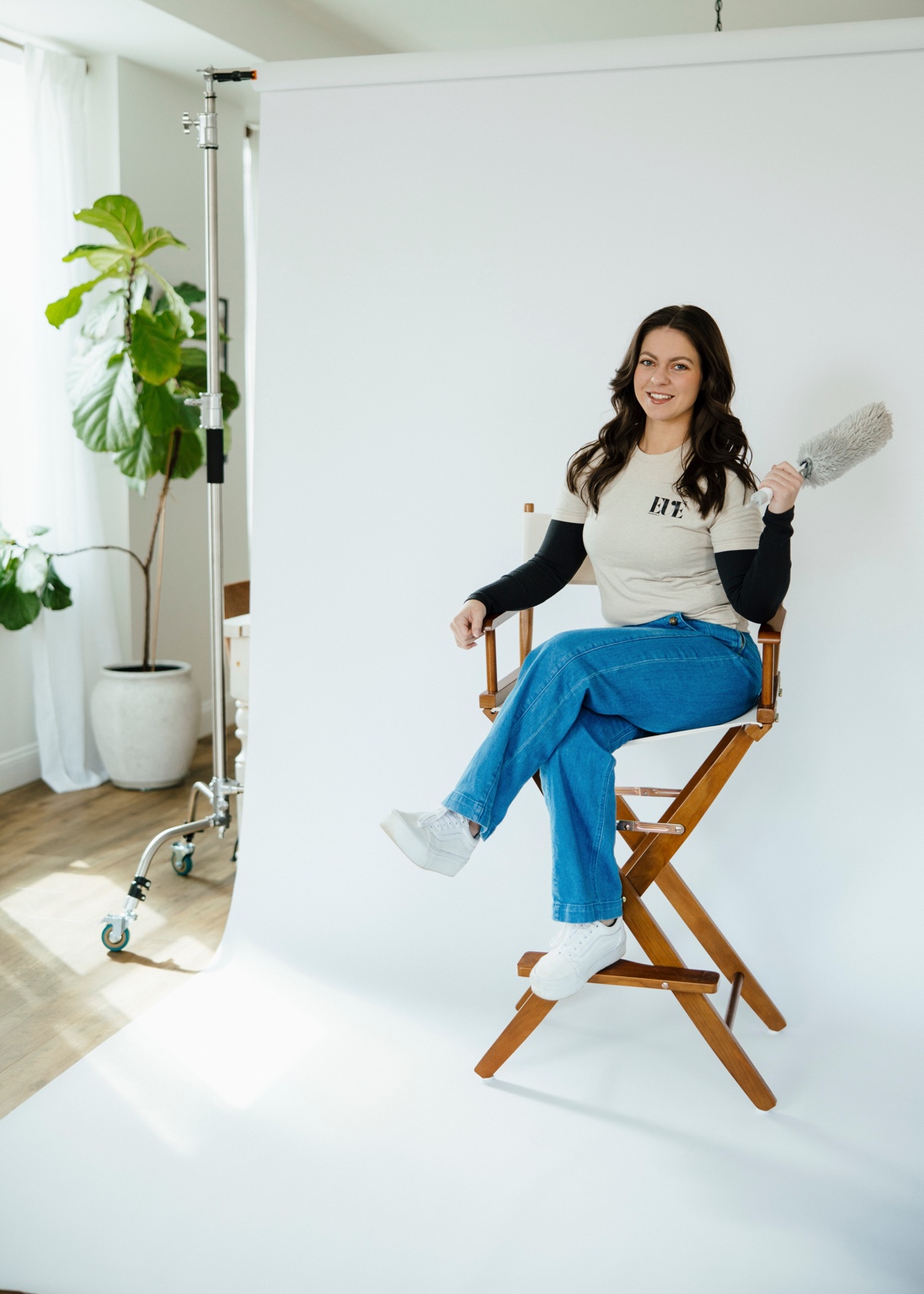 Portrait of the owner of EVE Home Services sitting in a studio chair.